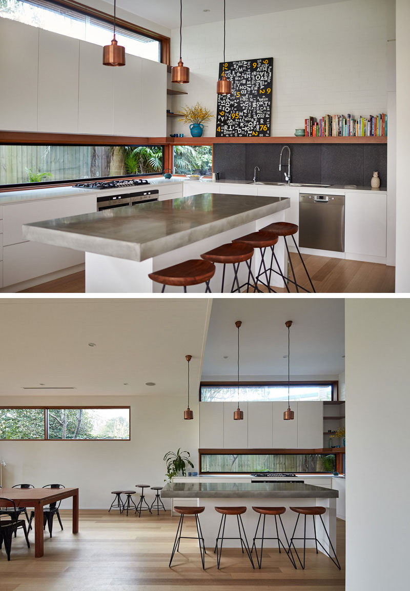 12 Inspirational Examples Of Letterbox Windows In Kitchens // The lower letterbox window in this kitchen replaces a backsplash, while the upper one adds to the bright and airy feeling of the entire home, as it carries light throughout the rest of the bottom level of the house.