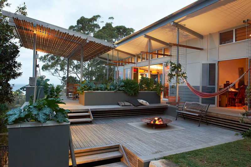 13 Multi-Level Backyards To Get You Inspired For A Summer Backyard Makeover // An entertaining area with a firepit and a dining area make up the two main levels of this backyard in Avoca Beach, Australia.