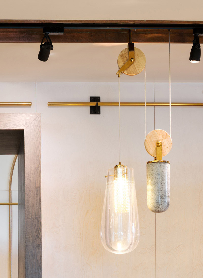 This restaurant, designed by Atelier I-N-D-J and located in Shanghai, China, includes pendant lighting on a pulley system, allowing them to adjust the height of the lights when needed.