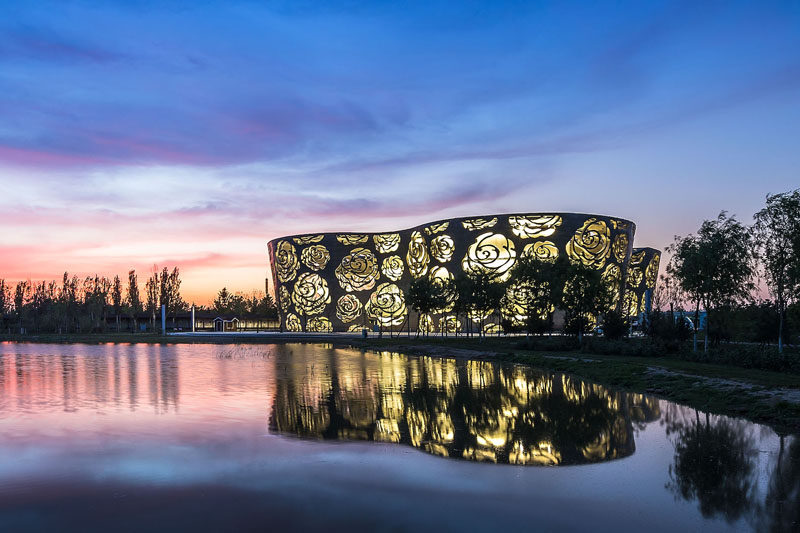 The world's first Rose Museum has opened in Beijing, China, and it's covered by a stainless steel facade that measures in at 984 ft (300m) long and 55ft (17m) high and is perforated by a rose-shaped pattern.