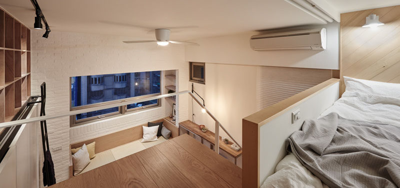 In this small apartment, the bed is located on a mezzanine level.