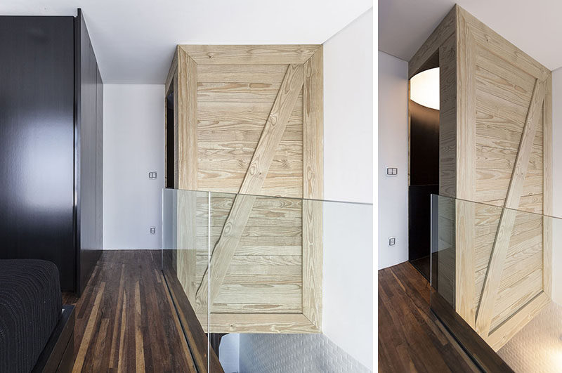 A wooden box hides the top of a spiral staircase and provides a place to house a light to brighten the stairs when it's dark.