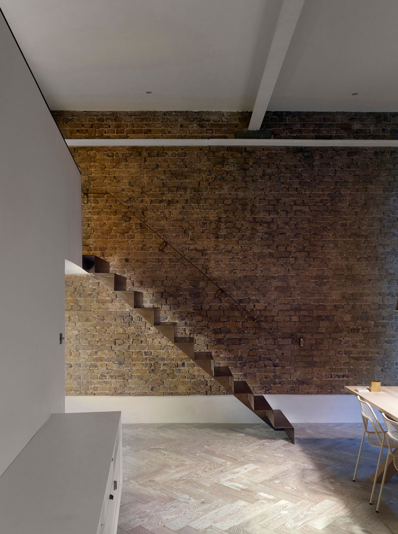 As part of the refurbishment of an apartment in Hackney, North London, Bell Phillips Architects designed minimalist stairs made from 6mm thick folded steel.