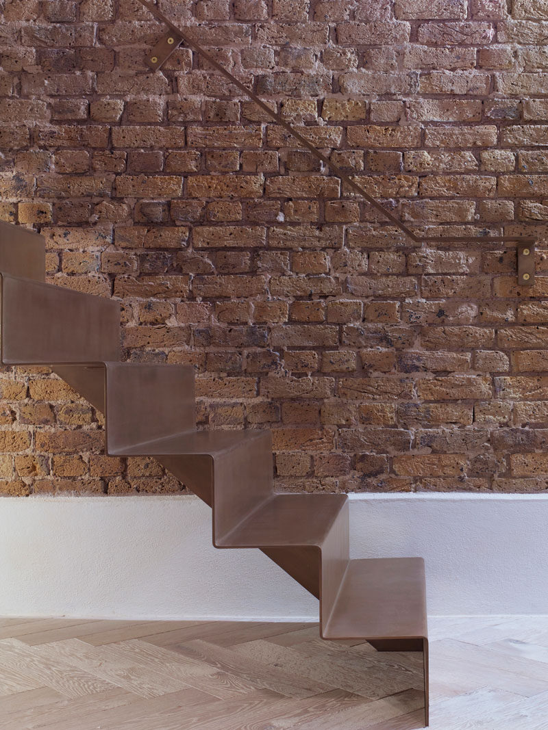 As part of the refurbishment of an apartment in Hackney, North London, Bell Phillips Architects designed minimalist stairs made from 6mm thick folded steel.