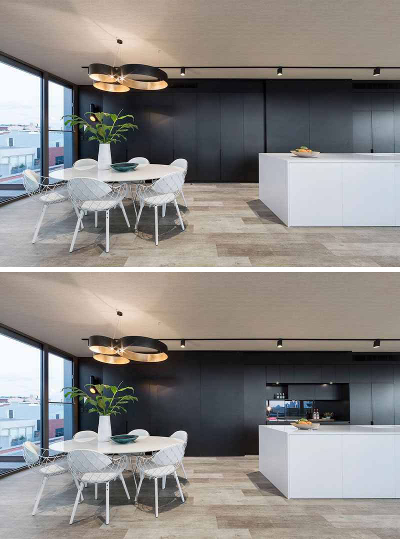 This black wall of cabinetry has a sliding panel that can cover part of the kitchen up when you don't want it on display.