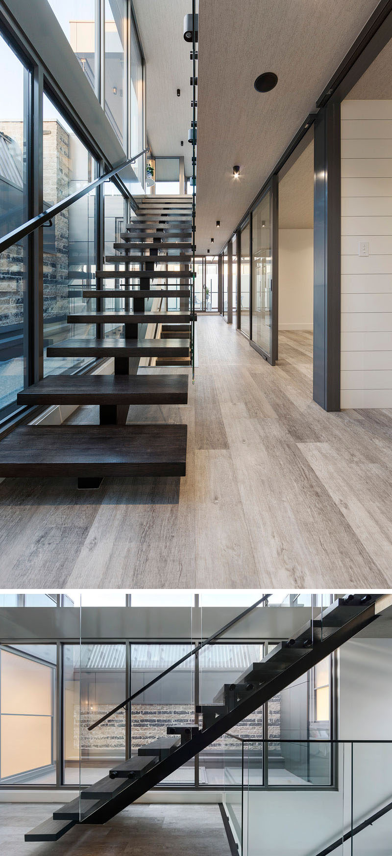 Black steel and dark wood stairs lead you to the lower levels of this home.