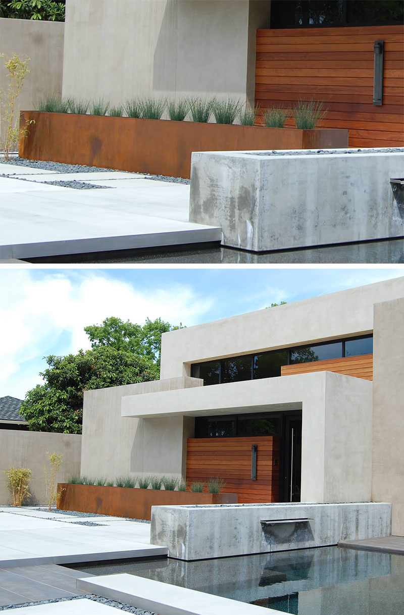 9 Ideas For Including Weathering Steel Planters In Your Garden // The color of the weathered steel of this oversized planter matches that of the wood doors on the exterior of this home and creates a tied together look and feel. #SteelGardenPlanters #WeatheredSteelPlanters #CortenSteelPlanters #Landscaping #GardenIdeas #PlanterIdeas