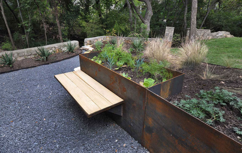 9 Ideas For Including Weathering Steel Planters In Your Garden // This planter / bench combination made from wood and weathered steel lets someone sit and enjoy the garden.  #SteelGardenPlanters #WeatheredSteelPlanters #CortenSteelPlanters #Landscaping #GardenIdeas #PlanterIdeas