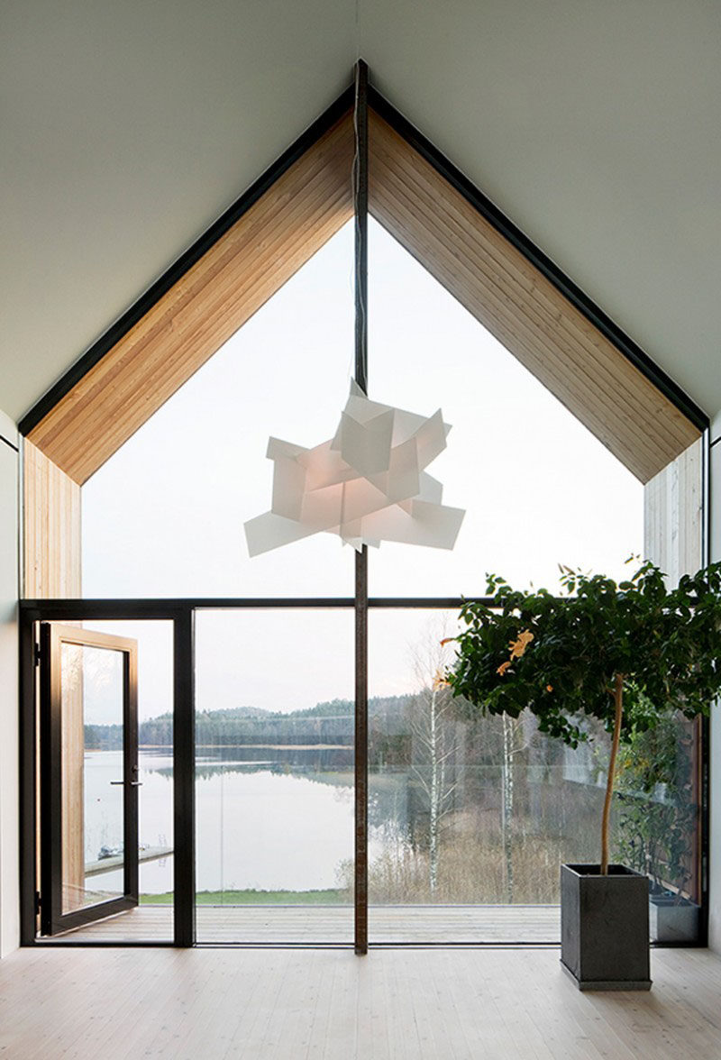 15 Awesome Examples Where Windows Follow The Roofline // This wall of glass offers incredible views of the lake outside and matches the angles of the roof while also following the lines of the walls.