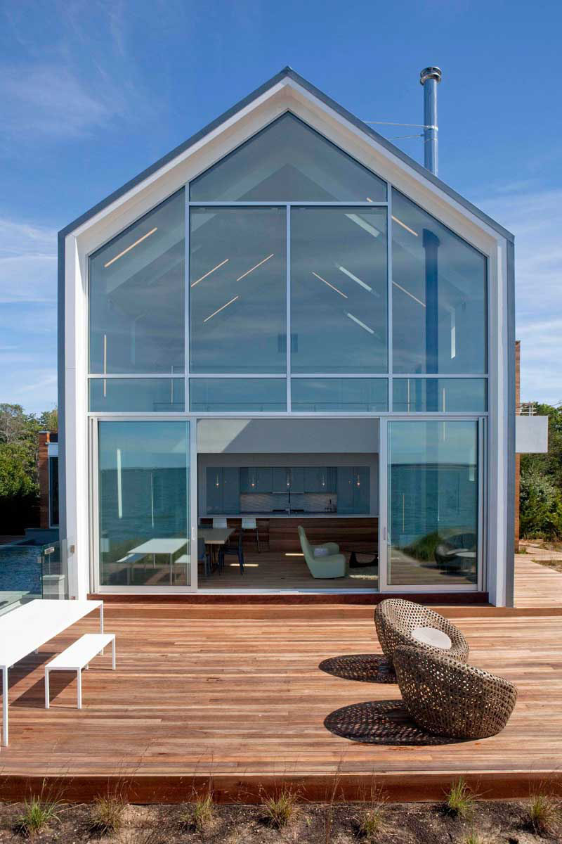 15 Awesome Examples Where Windows Follow The Roofline // This rear window covers the entirety of the back of the house and fits perfectly into the angles of the home.