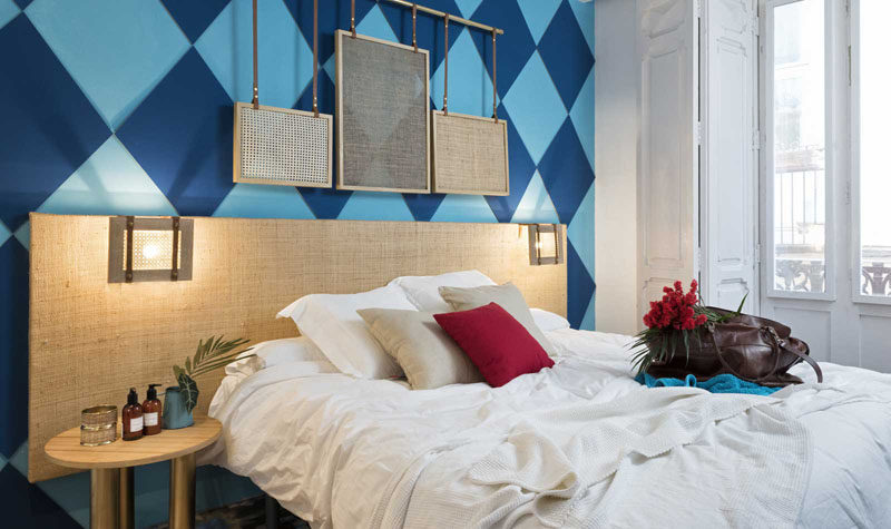 Wall Decor Inspiration - Bold Graphics Cover The Walls Of This Spanish Hostel // A two-tone blue diamond wall is a bold choice for this hostel room.
