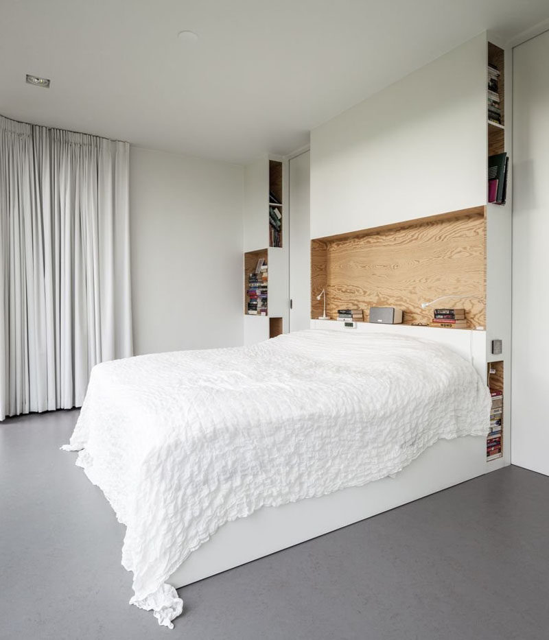 HEADBOARD DESIGN IDEA - Include A Built-In Shelf // Holding books, a speaker, lights, and a clock, this built-in shelf shows just how handy having one right right above your bed can be.