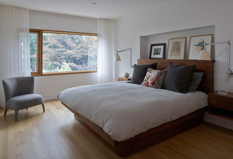 HEADBOARD DESIGN IDEA - Include A Built-In Shelf // The photos and paintings on display in this large built-in shelf are protected by the wood headboard just beneath it.