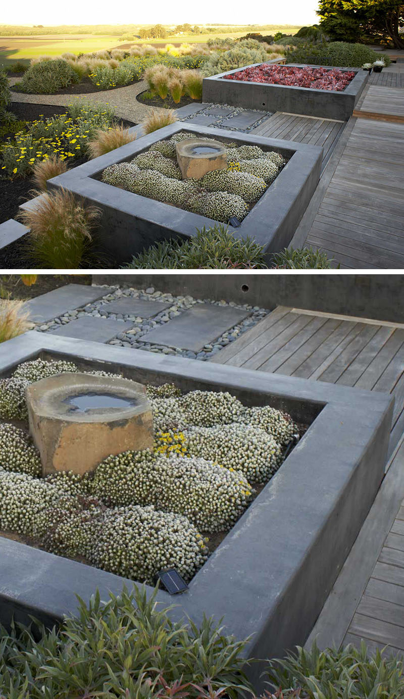 10 Inspirational Ideas For Including Custom Concrete Planters In Your Yard // Custom concrete planters were designed for this garden, and the designers have paired them with Ipe decking to create a contemporary look.