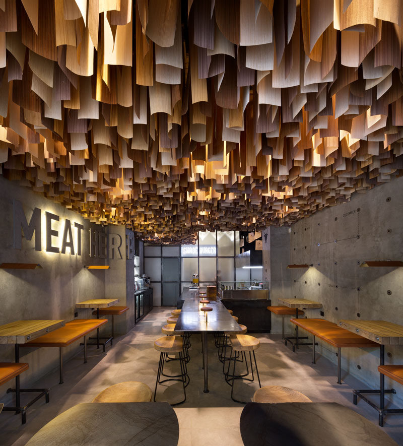 This contemporary restaurant has an artistic ceiling detail made from hundreds of wood veneer sheets.