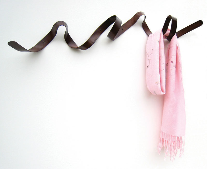 11 Creative Coat Hooks To Keep Your Clothes And Bags Off The Floor // Beautiful and unique enough to be used as a piece of wall art when not in use, this coat rack can hold jackets, purses and umbrellas. #CoatHooks #WallHook #ModernWallHook