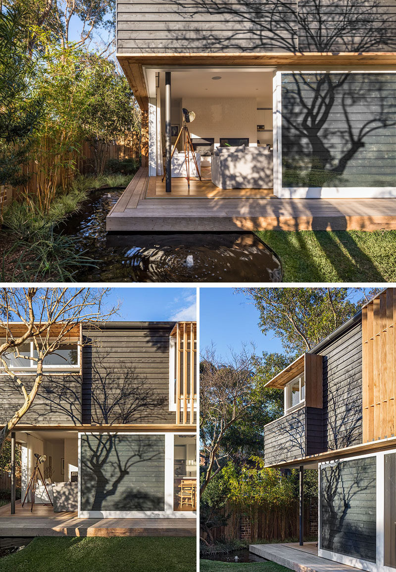 The living room in this home has large sliding doors that open up the space to the backyard and nearby water feature.