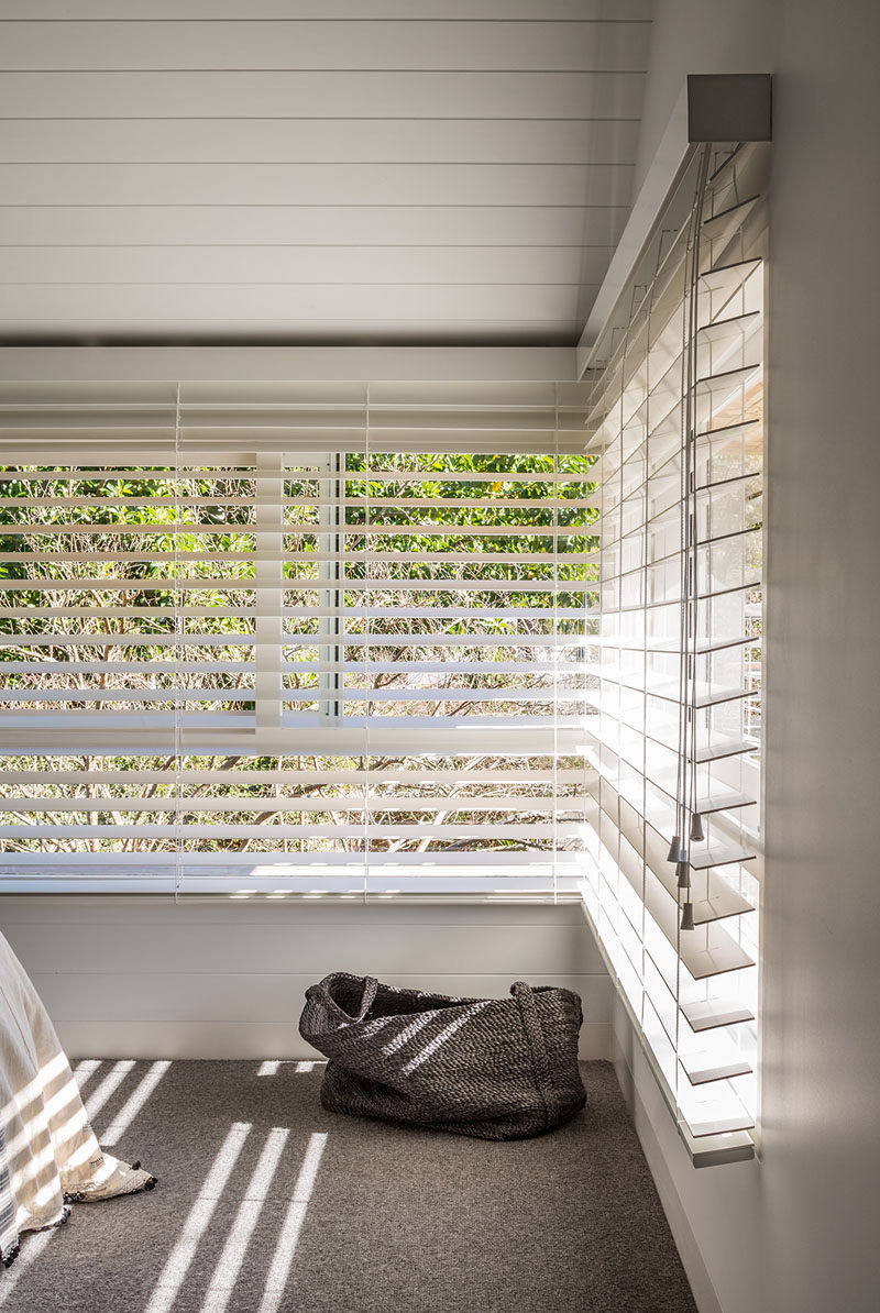 Simple blinds the same color as the walls, shade this bedroom from the sun and provide privacy when needed.