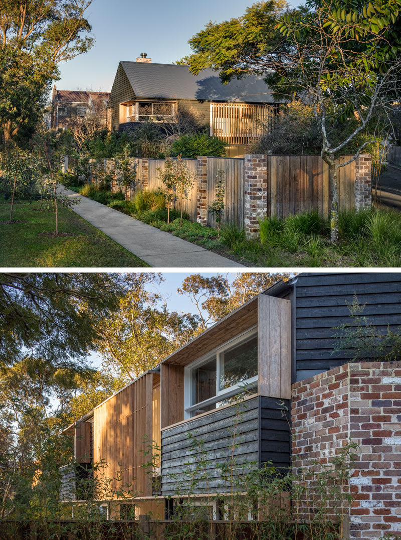 This Australian home has windows that are surrounded by timber shadow rails and screens, and the fence is a combination of wood and bricks to match the home.
