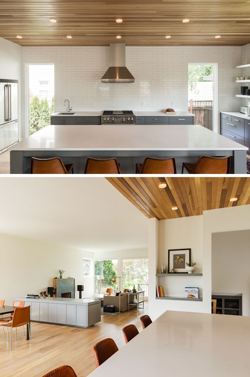 In this kitchen, two large 8 foot tall windows are evenly spaced apart providing plenty of natural light to the space, with the white tiles and countertops helping to reflect the light and make the space appear brighter and larger.