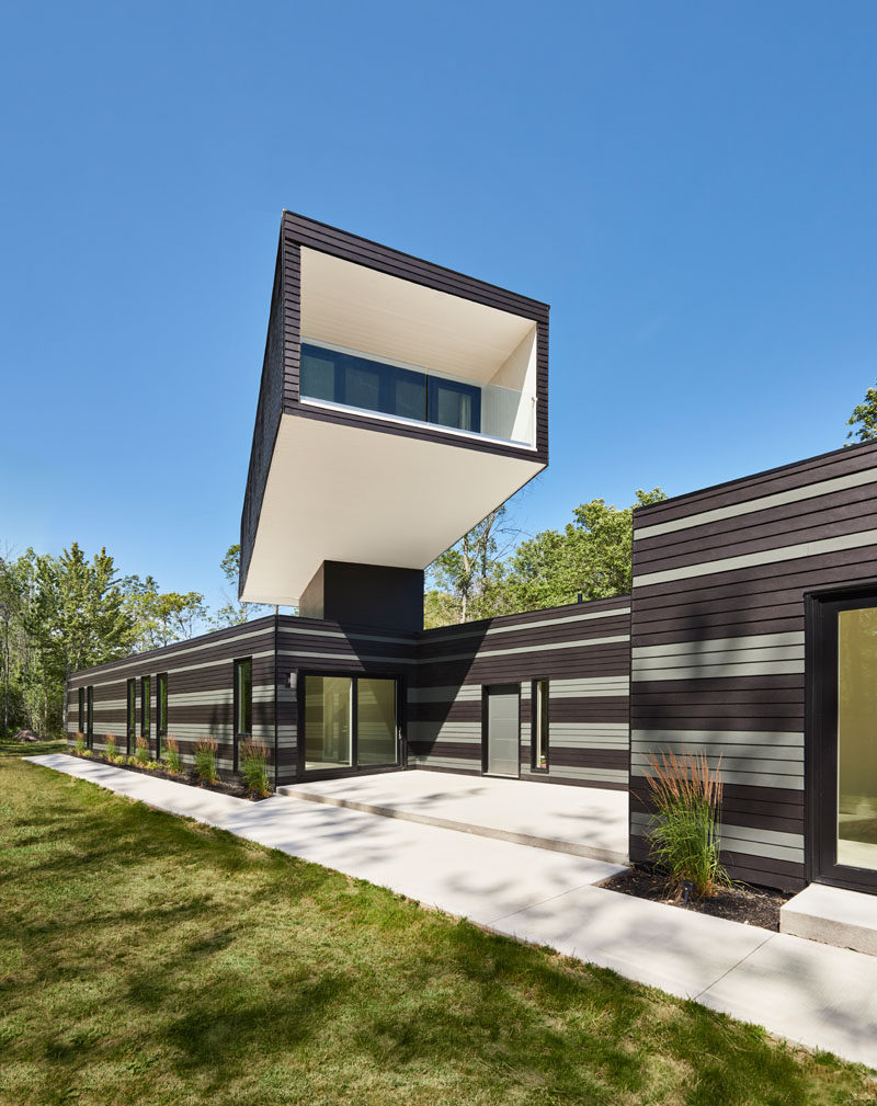 This Canadian home features a master bedroom tower that overlooks a green roof and has views of the lake.