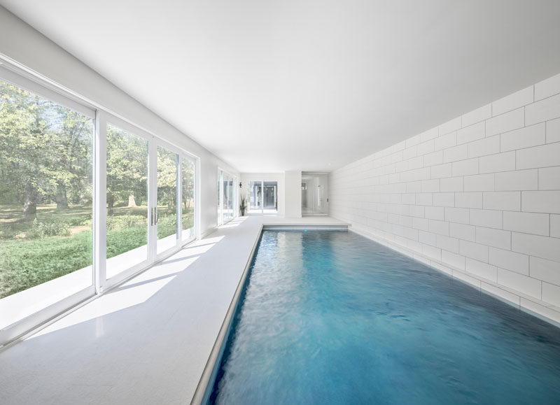 This indoor swimming pool area opens to the garden outside via large sliding doors.