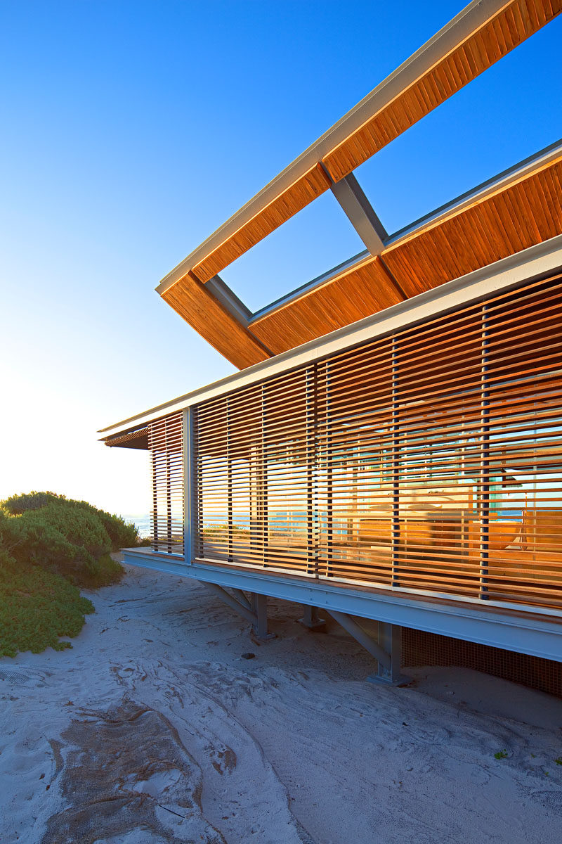 Slatted hardwood shutters cover this vacation house and add privacy and security.