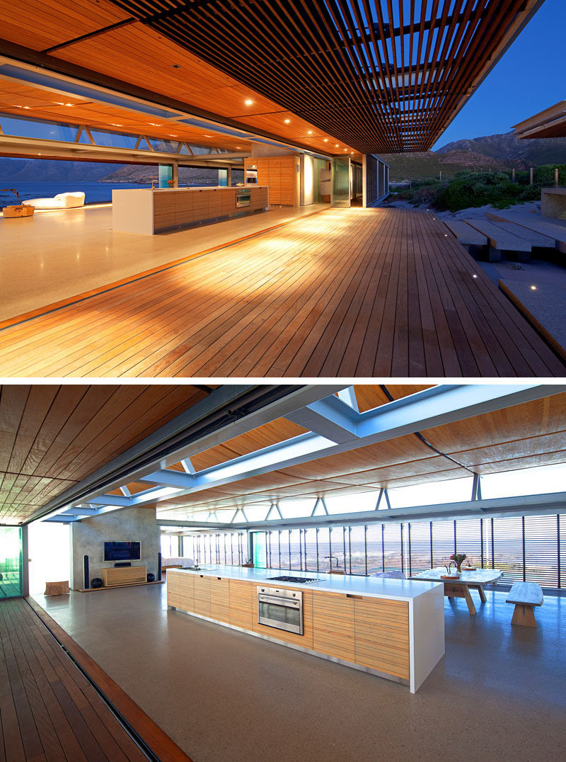 The kitchen of this vacation house is a large single long island and a wall of cabinets.