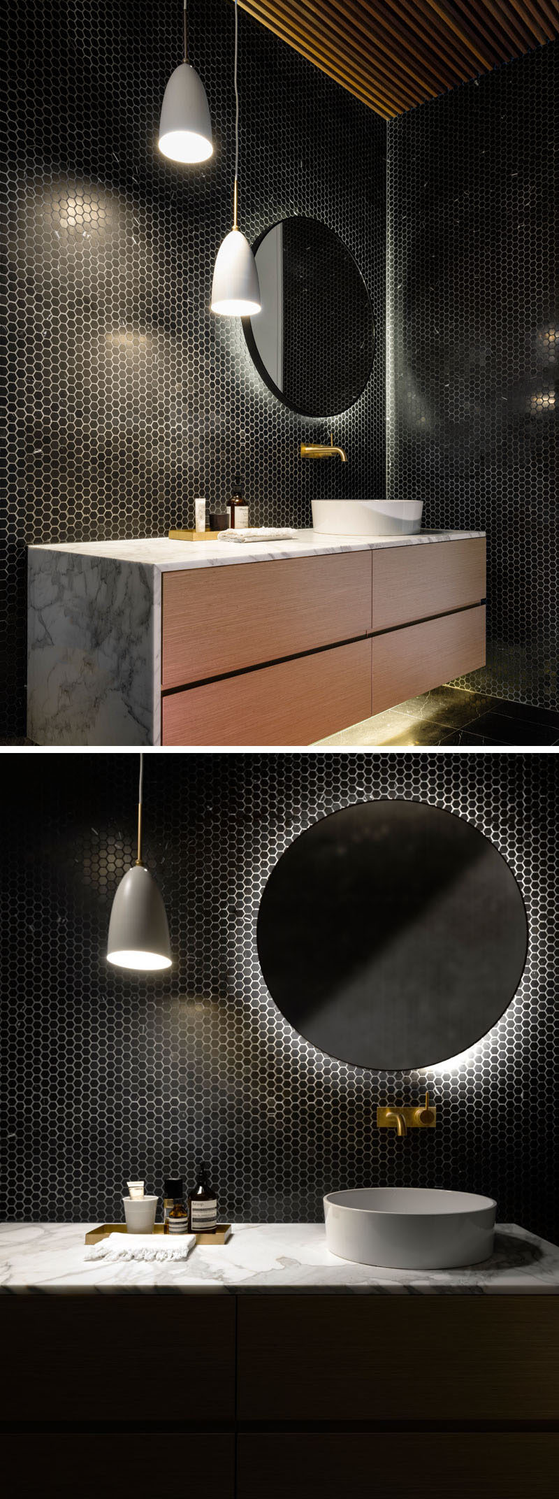 This bathroom has its walls covered in tiny black hexagonal tiles, and the vanity and mirror both feature hidden lighting.