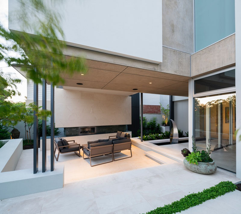 This home has multiple outdoor areas, like this outdoor living area with a fireplace.