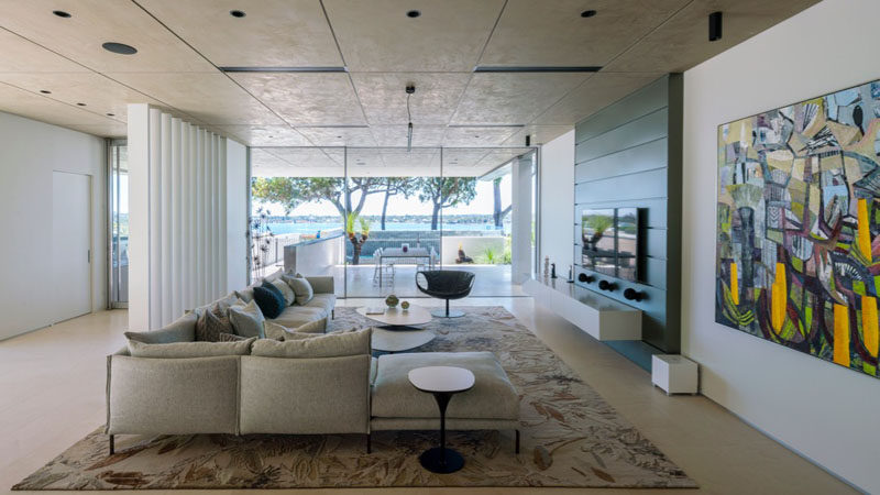 This living room has park and river views through the floor-to-ceiling windows. And outdoor dining area also shares the views.