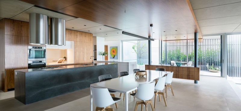 This kitchen and dining area share the same space, with another small seating area just outside.