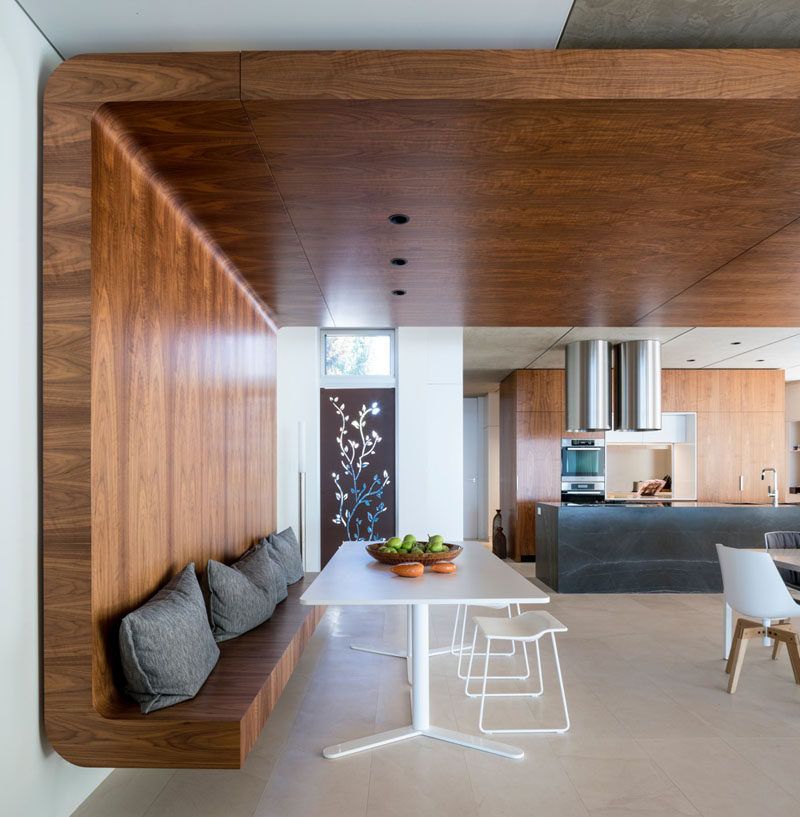 A curved wooden bench wraps around onto the ceiling and across the room.