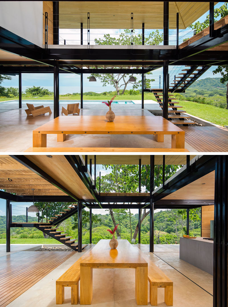 A large wooden dining table with bench seating creates a relaxed dining environment in this home.