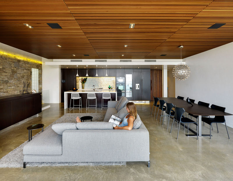 A wooden ceiling covers the living and dining area of this home, with the kitchen also sharing the same space.