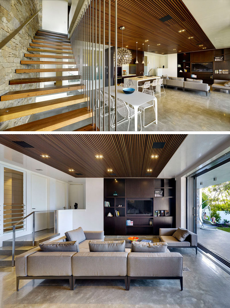 Stone has been used on the wall next to the stairs, and the designers included built-in cabinetry in the living room.