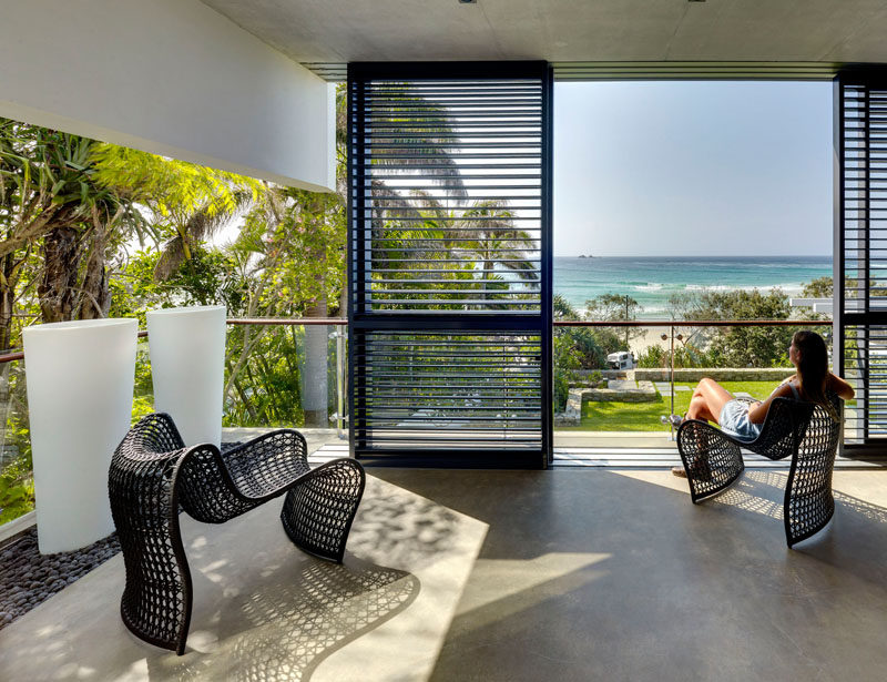 This covered balcony has views of the beach across the road.