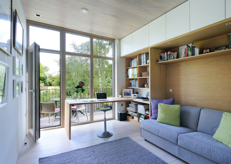 This home office has built-in shelving and space for a sofa. It also opens out onto a little deck with enough room for a couple of chairs.