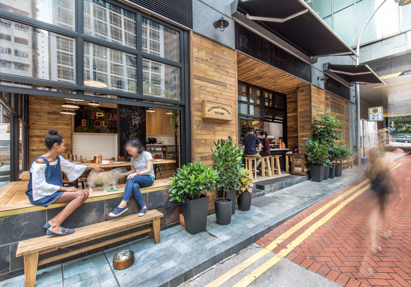 A brand new coffee shop has recently opened in Hong Kong, and they have dhas transformed this corner site and the character of the neighborhood by using warm materials and emphasizing indoor-outdoor engagement.