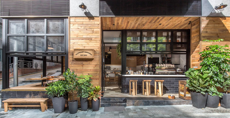 A brand new coffee shop has recently opened in Hong Kong, and they have dhas transformed this corner site and the character of the neighborhood by using warm materials and emphasizing indoor-outdoor engagement.