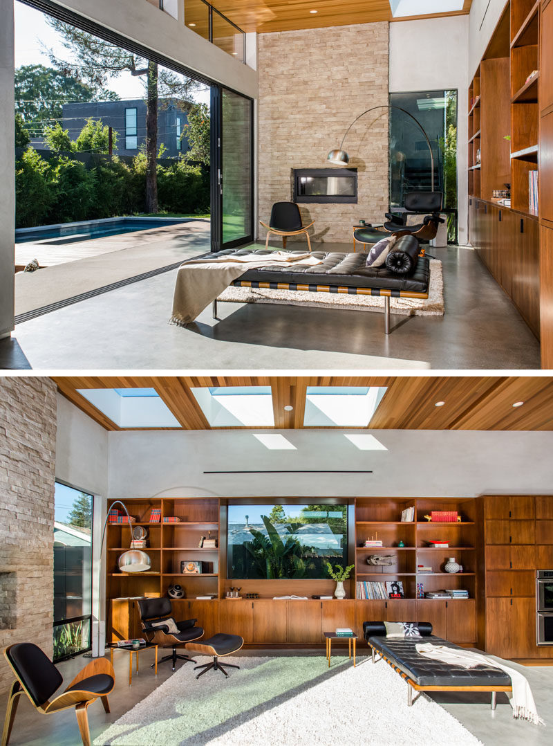 In this library area, there's a fireplace with a stone surround, and large sliding doors make it the perfect place to lounge and get a bit of sun.