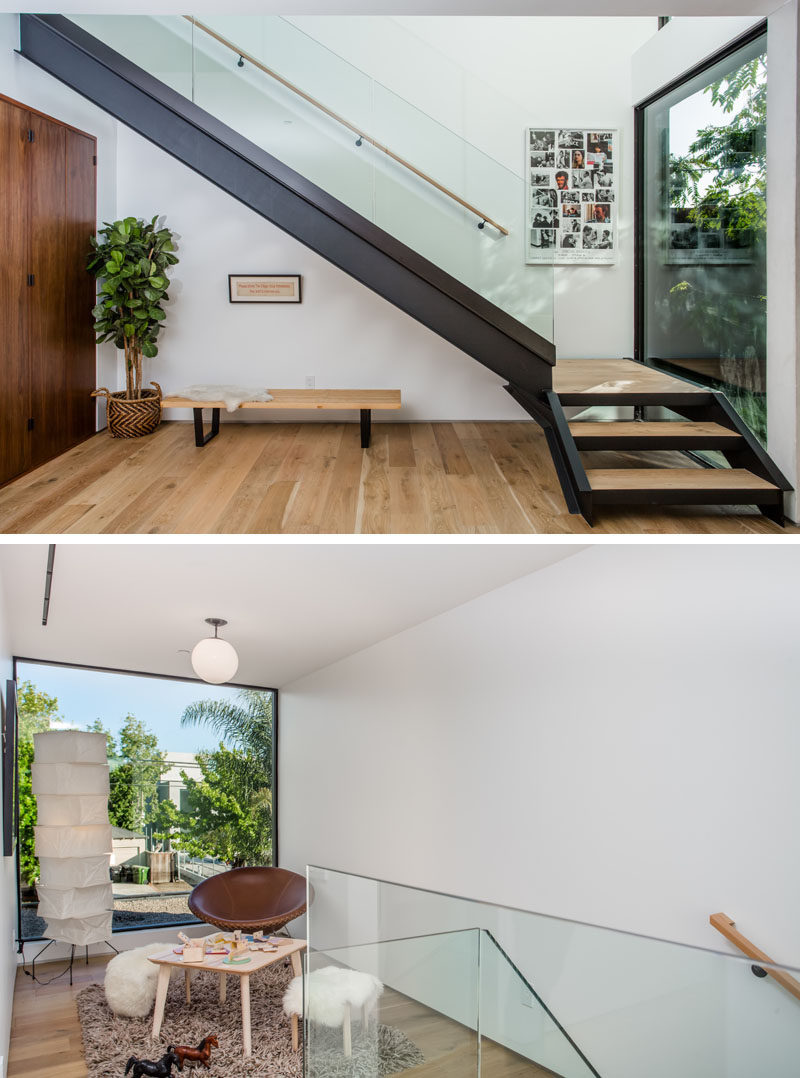 Steel, wood and glass stairs lead you to the second floor of this home, and at the top of the stairs there's a small sitting area with a large window that has views of the street.