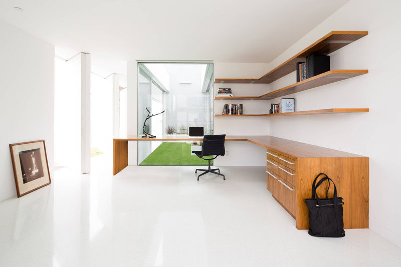 6 Design Ideas For Adding Corner Shelves To Your Home // Float Them --- Long, floating shelves running the length of this desk and tucked into the corner provide lots of extra storage in this home office.