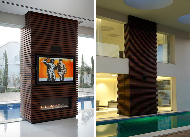 Wrapping an unsightly pillar or inconvenient wall in wood slats and installing a television and fireplace within its design, is a great way to turn otherwise dead space in your home into a functional and unique design detail.