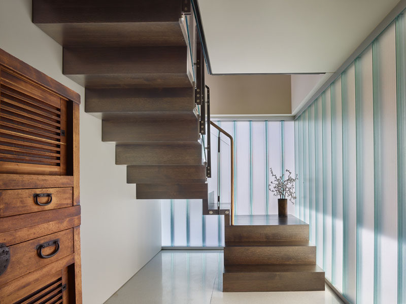 Upon entering this float home, two exterior walls of channel glass are visible and they allow abundant natural light for the entry and stair, and also maintain privacy.