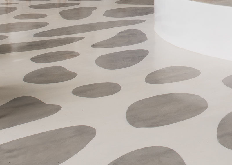 FLOORING IDEA - The concrete flooring in this hotel was painted using a stencil, creating a look that resembles stones embedded into the floor.