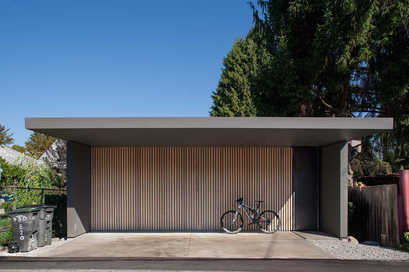 18 Inspirational Examples Of Modern Garage Doors // The thin light wood vertical panels on this garage door make for a modern statement and a unique door.