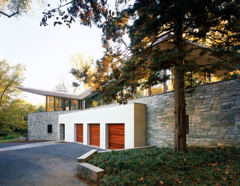 18 Inspirational Examples Of Modern Garage Doors // These three wooden garage doors draw your focus and contrast the white that surrounds them.