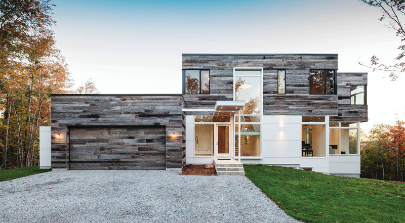 18 Inspirational Examples Of Modern Garage Doors // Covered in reclaimed wood panels, this garage door matches the exterior of the garage as well as the second level of the house.