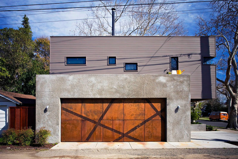 18 Inspirational Examples Of Modern Garage Doors // Angular strips of steel mesh break up the square weathered steel panels of this garage door and add an artistic flair to the home.